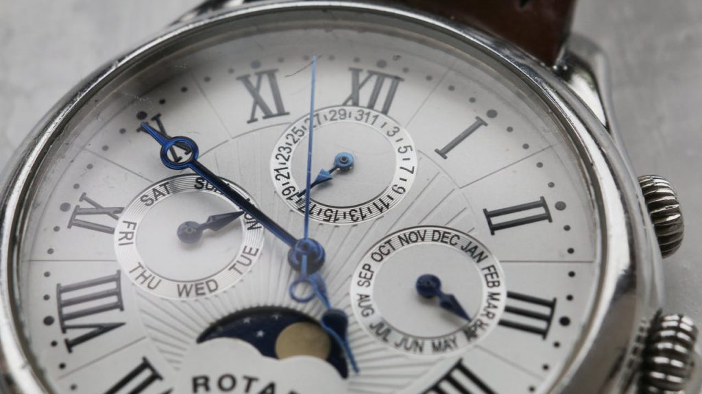 Detailed close-up of a vintage wristwatch showcasing intricate analog design.